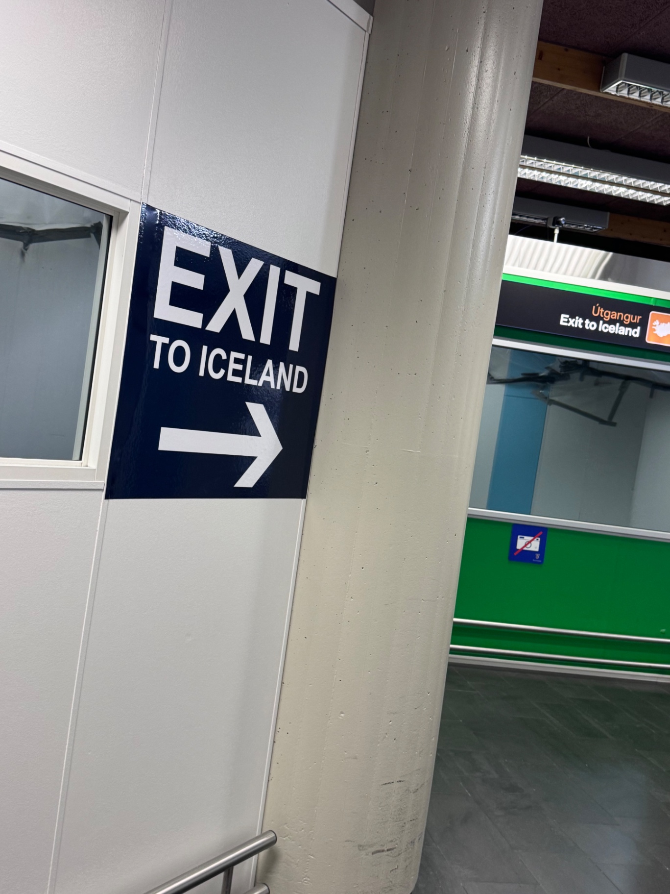 Signs at Keflavík Airport customs reading Exit to Iceland and Útgangur, above the green channel