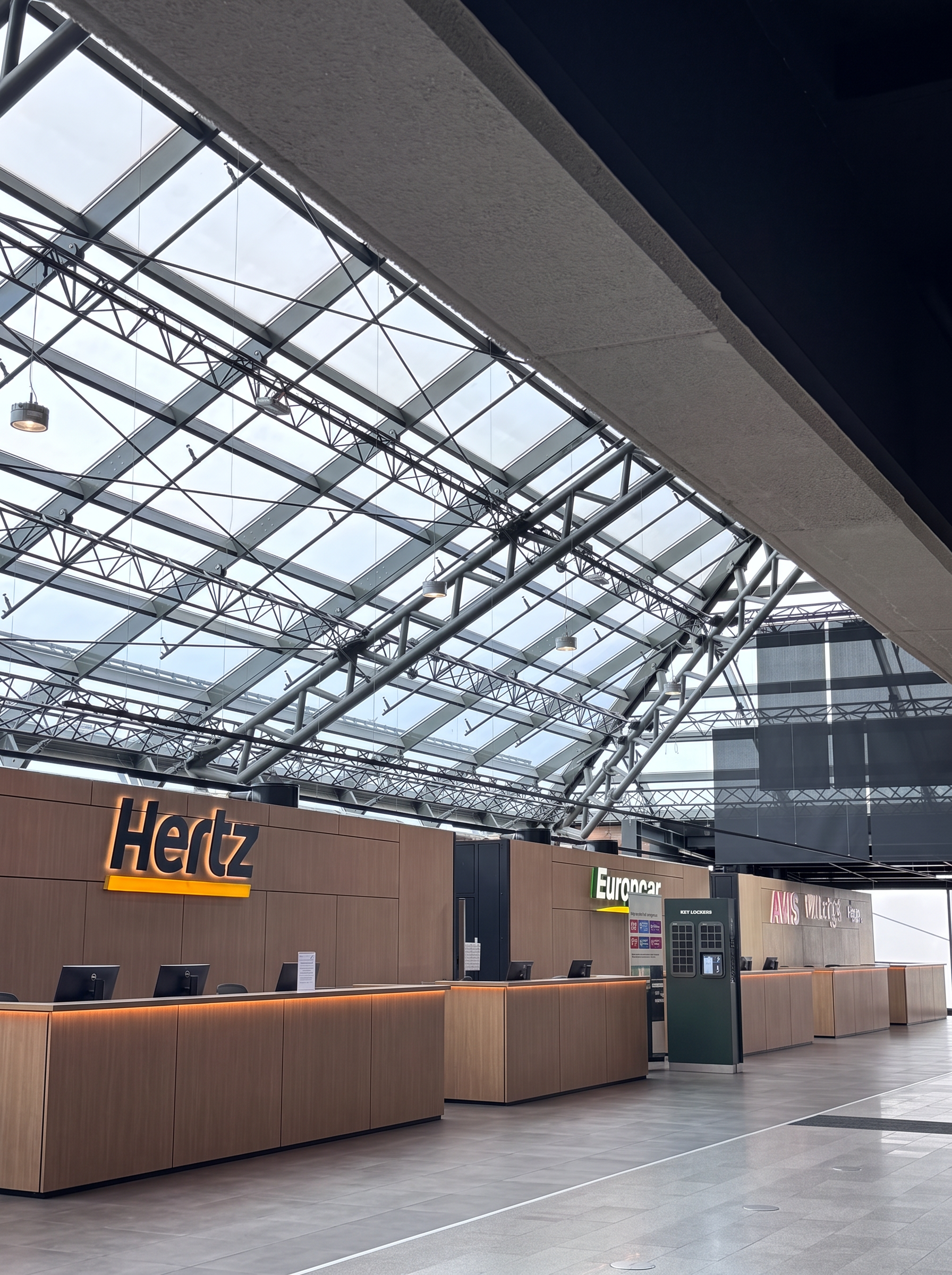 Car rental desks at Keflavík Airport, with Hertz, Europcar and Avis counters and key lockers